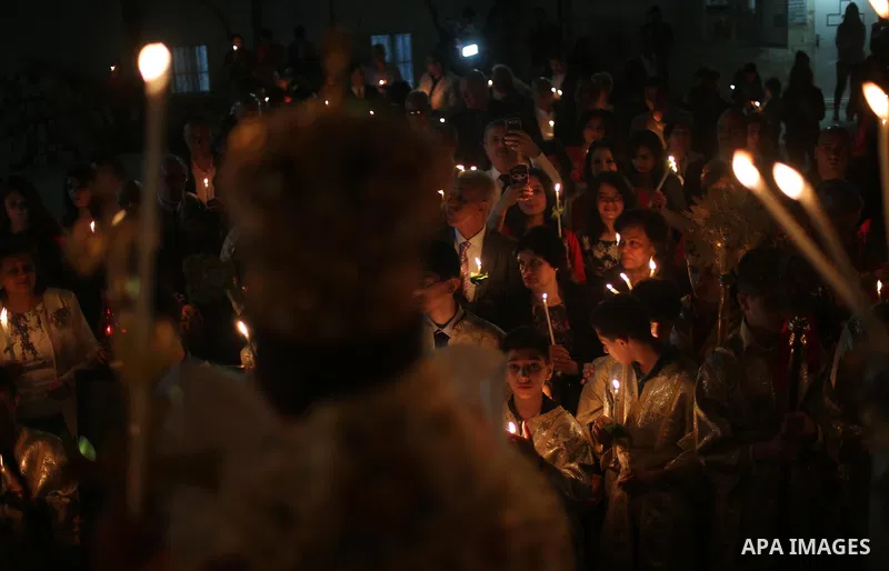 Orthodox Christian worshippers attend a prayer during the Easter Eve mass at the St. Porphyrios church in Gaza City, Saturday, April 15, 2017. Christians have gathered at the church for the fire ceremony that celebrates...