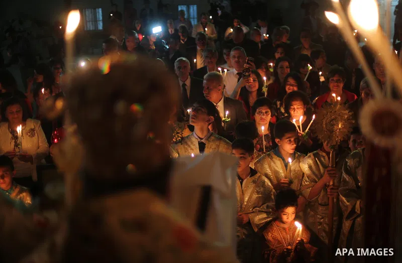 Orthodox Christian worshippers attend a prayer during the Easter Eve mass at the St. Porphyrios church in Gaza City, Saturday, April 15, 2017. Christians have gathered at the church for the fire ceremony that celebrates...
