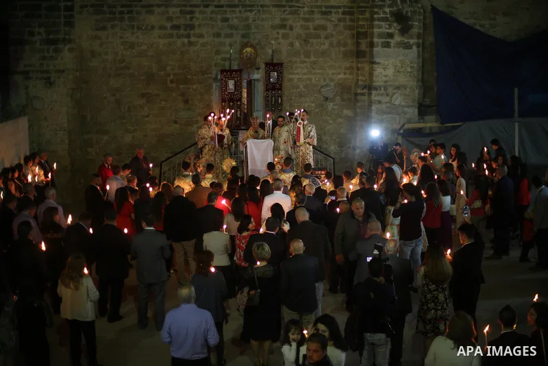 Orthodox Christian worshippers attend a prayer during the Easter Eve mass at the St. Porphyrios church in Gaza City, Saturday, April 15, 2017. Christians have gathered at the church for the fire ceremony that celebrates...