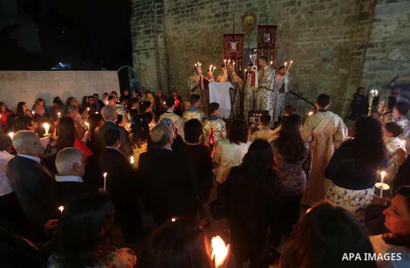 Orthodox Christian worshippers attend a prayer during the Easter Eve mass at the St. Porphyrios church in Gaza City, Saturday, April 15, 2017. Christians have gathered at the church for the fire ceremony that celebrates...