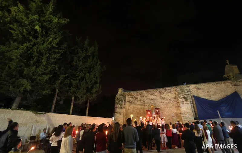 Orthodox Christian worshippers attend a prayer during the Easter Eve mass at the St. Porphyrios church in Gaza City, Saturday, April 15, 2017. Christians have gathered at the church for the fire ceremony that celebrates...
