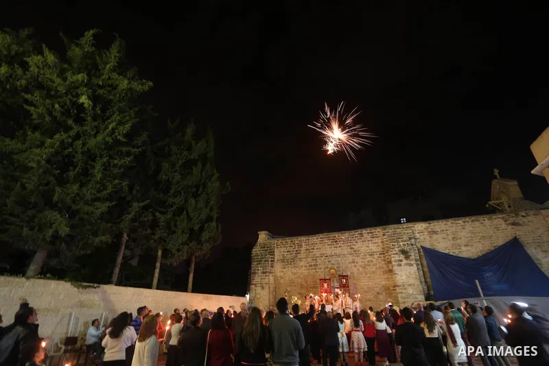 Orthodox Christian worshippers attend a prayer during the Easter Eve mass at the St. Porphyrios church in Gaza City, Saturday, April 15, 2017. Christians have gathered at the church for the fire ceremony that celebrates...