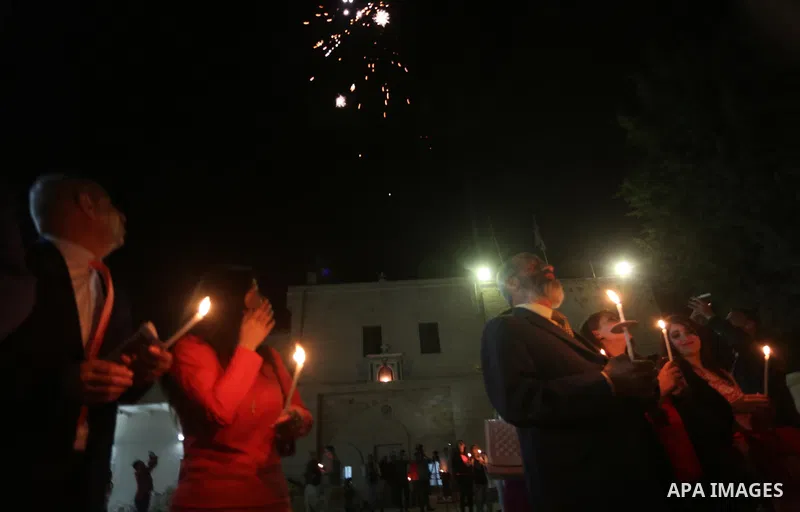 Orthodox Christian worshippers attend a prayer during the Easter Eve mass at the St. Porphyrios church in Gaza City, Saturday, April 15, 2017. Christians have gathered at the church for the fire ceremony that celebrates...
