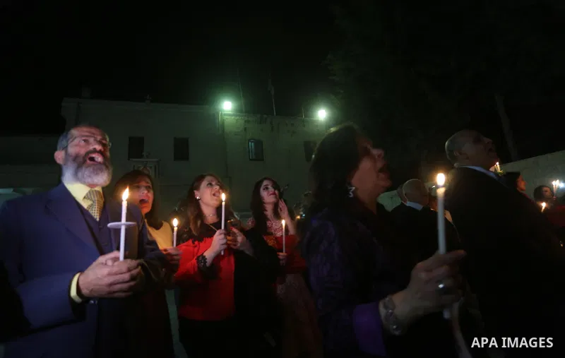 Orthodox Christian worshippers attend a prayer during the Easter Eve mass at the St. Porphyrios church in Gaza City, Saturday, April 15, 2017. Christians have gathered at the church for the fire ceremony that celebrates...