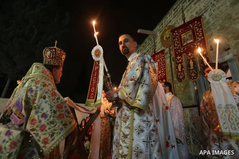 Orthodox Christian worshippers attend a prayer during the Easter Eve mass at the St. Porphyrios church in Gaza City, Saturday, April 15, 2017. Christians have gathered at the church for the fire ceremony that celebrates...