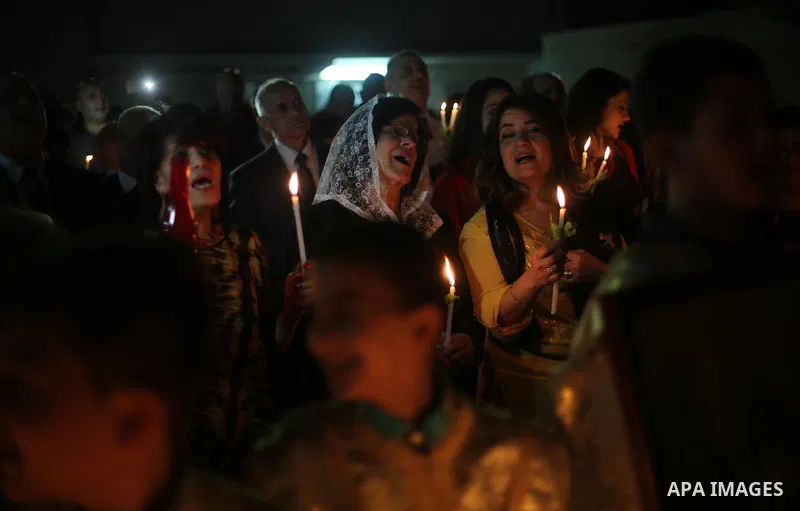 Orthodox Christian worshippers attend a prayer during the Easter Eve mass at the St. Porphyrios church in Gaza City, Saturday, April 15, 2017. Christians have gathered at the church for the fire ceremony that celebrates...