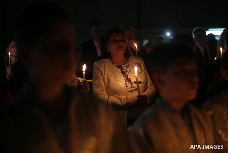 Orthodox Christian worshippers attend a prayer during the Easter Eve mass at the St. Porphyrios church in Gaza City, Saturday, April 15, 2017. Christians have gathered at the church for the fire ceremony that celebrates...