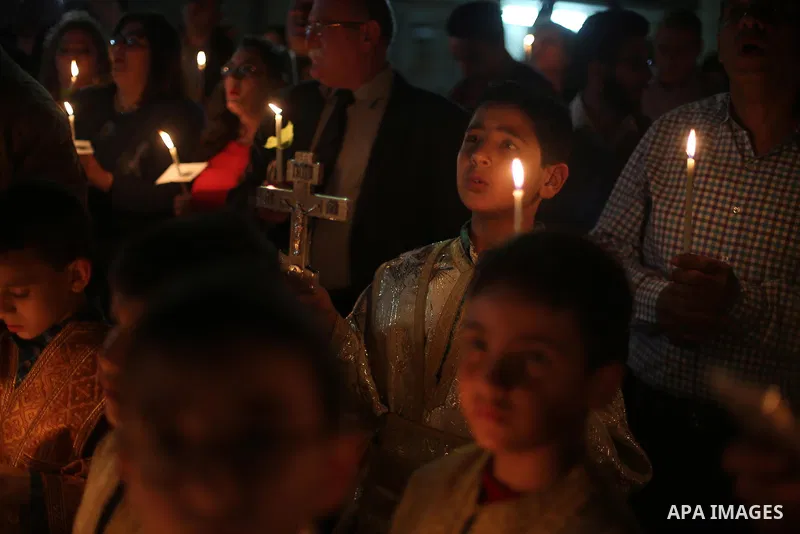 Orthodox Christian worshippers attend a prayer during the Easter Eve mass at the St. Porphyrios church in Gaza City, Saturday, April 15, 2017. Christians have gathered at the church for the fire ceremony that celebrates...