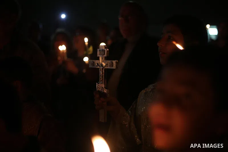 Orthodox Christian worshippers attend a prayer during the Easter Eve mass at the St. Porphyrios church in Gaza City, Saturday, April 15, 2017. Christians have gathered at the church for the fire ceremony that celebrates...