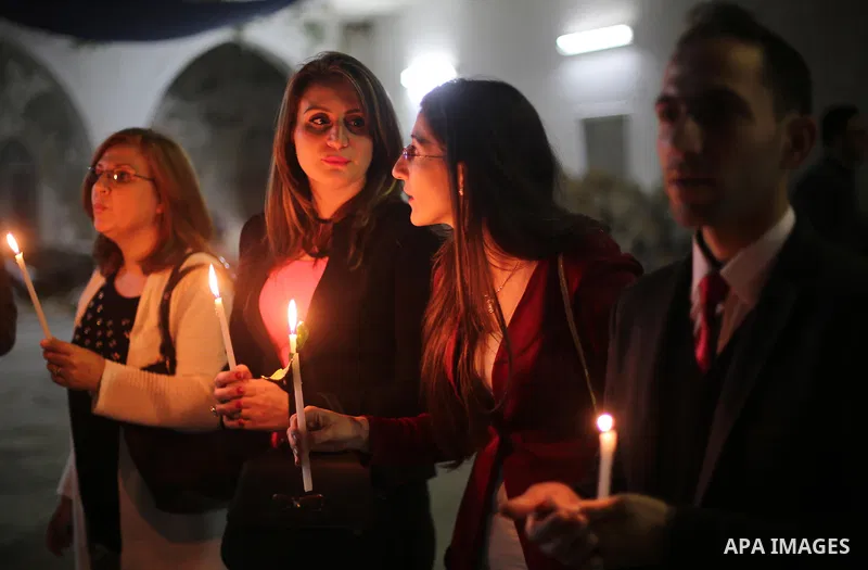 Orthodox Christian worshippers attend a prayer during the Easter Eve mass at the St. Porphyrios church in Gaza City, Saturday, April 15, 2017. Christians have gathered at the church for the fire ceremony that celebrates...