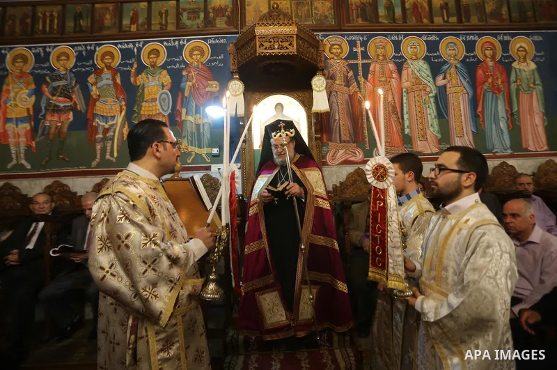Orthodox Christian worshippers attend a prayer during the Easter Eve mass at the St. Porphyrios church in Gaza City, Saturday, April 15, 2017. Christians have gathered at the church for the fire ceremony that celebrates...