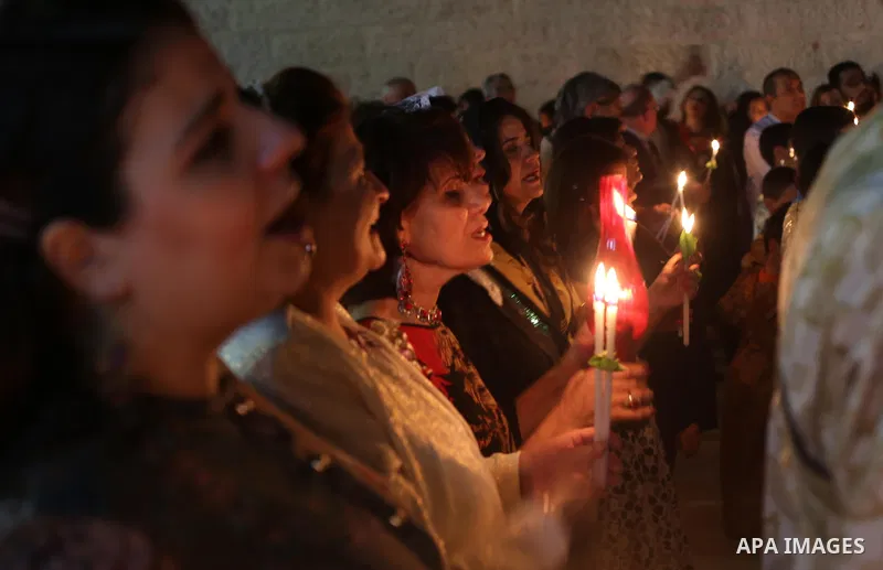 Orthodox Christian worshippers attend a prayer during the Easter Eve mass at the St. Porphyrios church in Gaza City, Saturday, April 15, 2017. Christians have gathered at the church for the fire ceremony that celebrates...