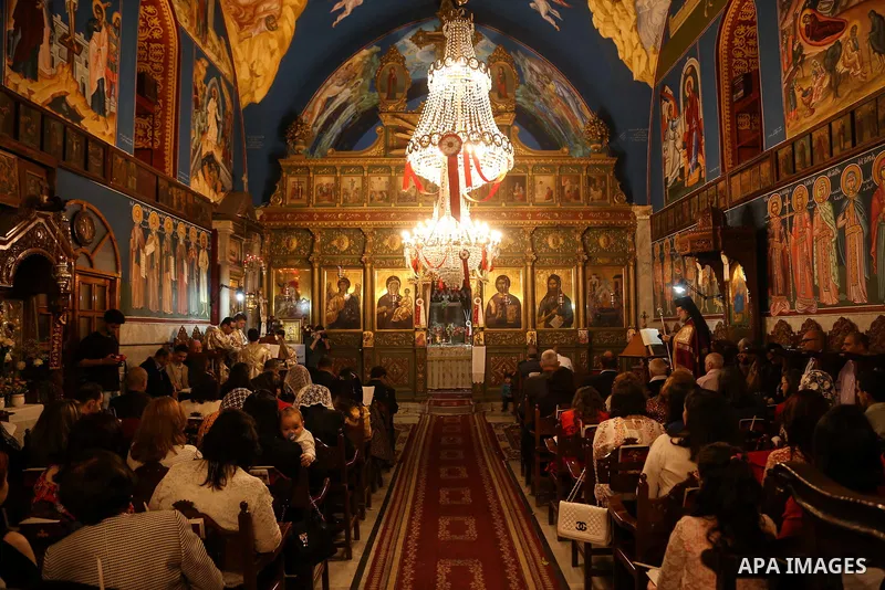 Orthodox Christian worshippers attend a prayer during the Easter Eve mass at the St. Porphyrios church in Gaza City, Saturday, April 15, 2017. Christians have gathered at the church for the fire ceremony that celebrates...