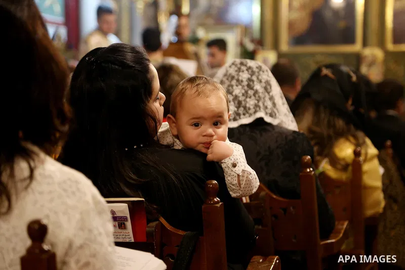 Orthodox Christian worshippers attend a prayer during the Easter Eve mass at the St. Porphyrios church in Gaza City, Saturday, April 15, 2017. Christians have gathered at the church for the fire ceremony that celebrates...