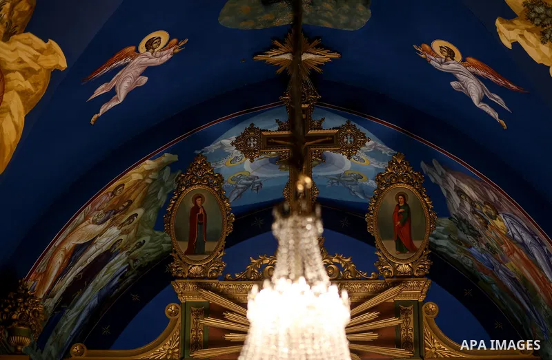Orthodox Christian worshippers attend a prayer during the Easter Eve mass at the St. Porphyrios church in Gaza City, Saturday, April 15, 2017. Christians have gathered at the church for the fire ceremony that celebrates...