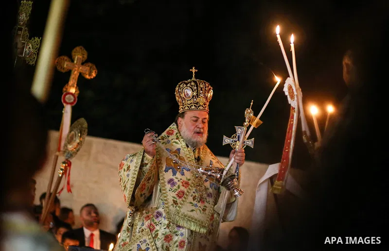 Archbishop Alexios leads the Easter Eve mass prayer at the St. Porphyrios church in Gaza City, Saturday, April 15, 2017. Christians have gathered at the church for the fire ceremony that celebrates Jesus' resurrection. P...