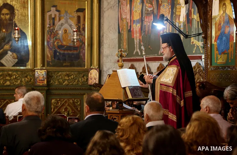 Orthodox Christian worshippers attend a prayer during the Easter Eve mass at the St. Porphyrios church in Gaza City, Saturday, April 15, 2017. Christians have gathered at the church for the fire ceremony that celebrates...