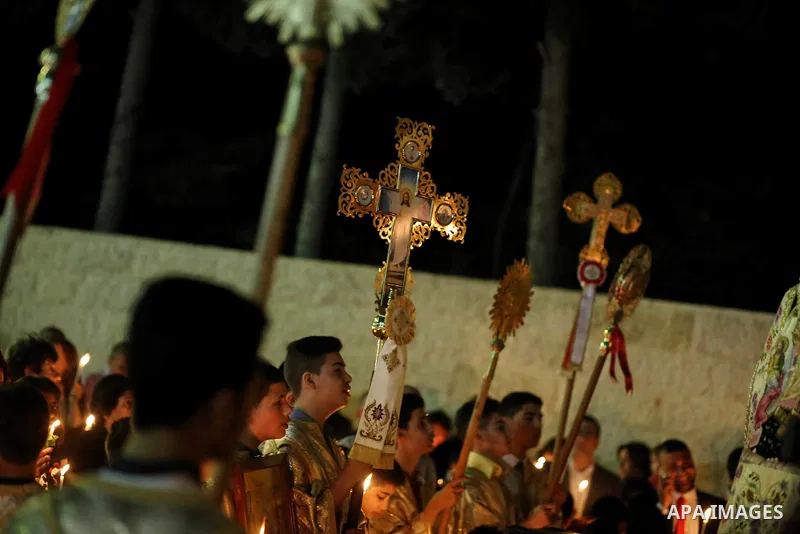 Orthodox Christian worshippers attend a prayer during the Easter Eve mass at the St. Porphyrios church in Gaza City, Saturday, April 15, 2017. Christians have gathered at the church for the fire ceremony that celebrates...