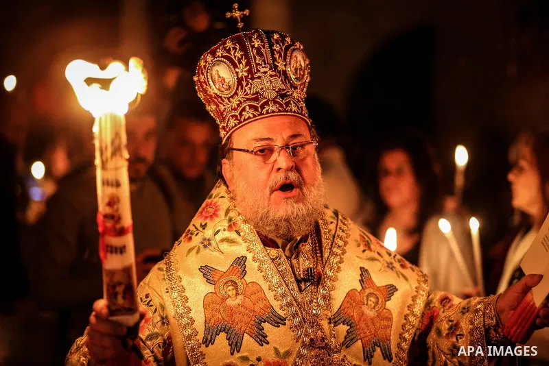 Archbishop Alexios leads the Easter Eve mass prayer at the St. Porphyrios church in Gaza City, Saturday, April 15, 2017. Christians have gathered at the church for the fire ceremony that celebrates Jesus' resurrection. P...