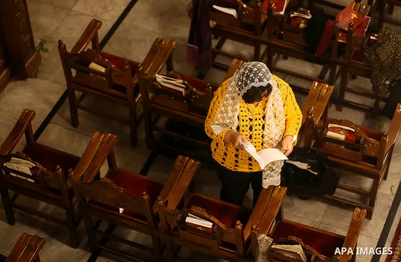 Orthodox Christian worshippers attend a prayer during the Easter Eve mass at the St. Porphyrios church in Gaza City, Saturday, April 15, 2017. Christians have gathered at the church for the fire ceremony that celebrates...