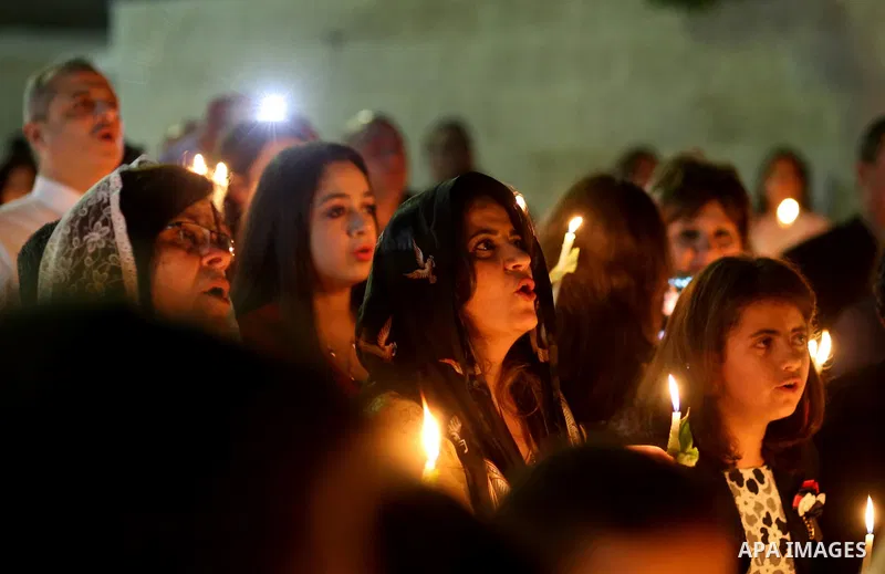 Orthodox Christian worshippers attend a prayer during the Easter Eve mass at the St. Porphyrios church in Gaza City, Saturday, April 15, 2017. Christians have gathered at the church for the fire ceremony that celebrates...