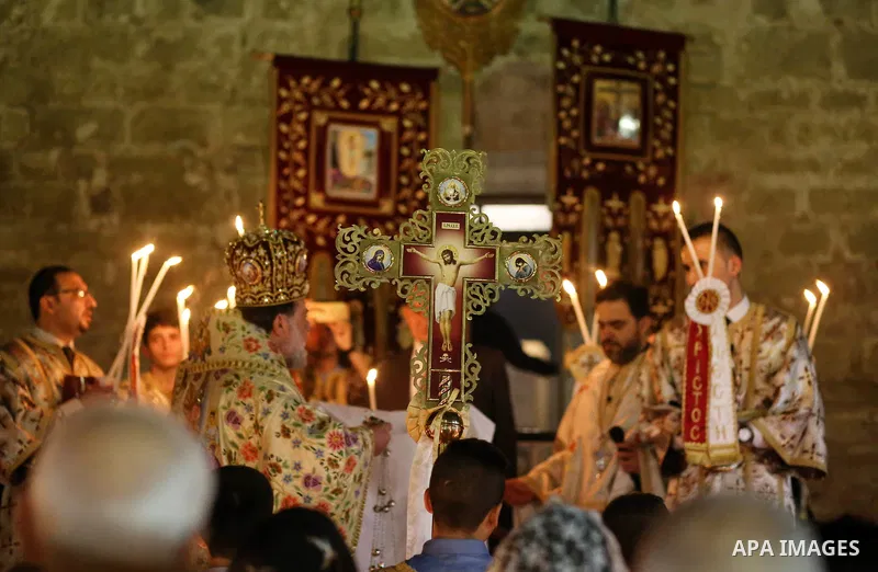 Archbishop Alexios leads the Easter Eve mass prayer at the St. Porphyrios church in Gaza City, Saturday, April 15, 2017. Christians have gathered at the church for the fire ceremony that celebrates Jesus' resurrection. P...