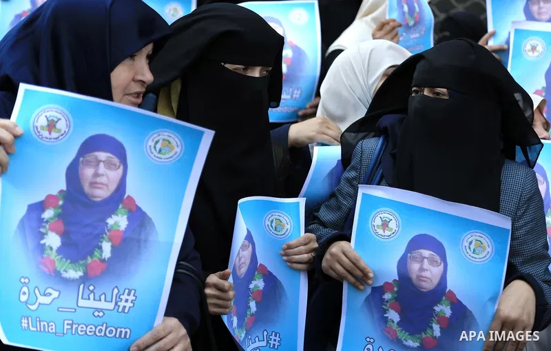 Palestinian supporters of the Islamic Jihad Movement hold posters bearing a portrait of Palestinian Lina al-Jarbouni, the longest-serving woman prisoner in Israeli jails, after she was released from the Israeli Hasharon...