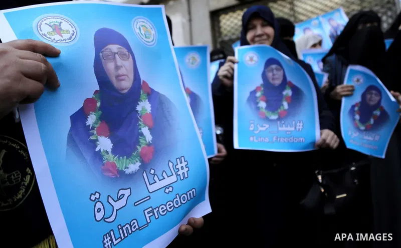Palestinian supporters of the Islamic Jihad Movement hold posters bearing a portrait of Palestinian Lina al-Jarbouni, the longest-serving woman prisoner in Israeli jails, after she was released from the Israeli Hasharon...