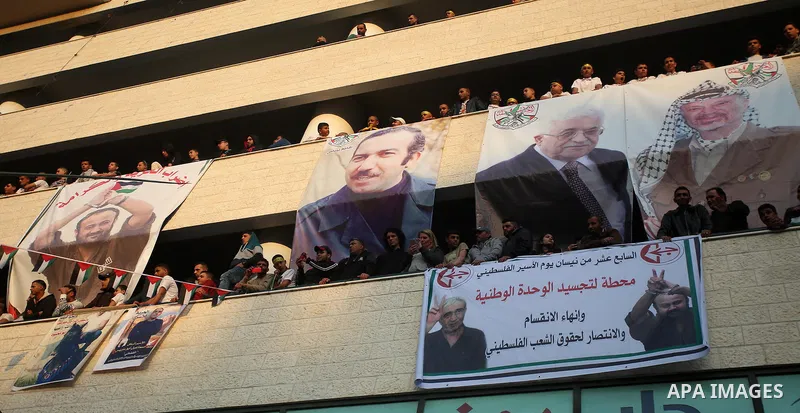 Palestinians hold pictures of relatives held in Israeli jails during a rally marking Palestinian Prisoner Day in the West Bank city of Nablus April 16, 2017. Photo by Stringer