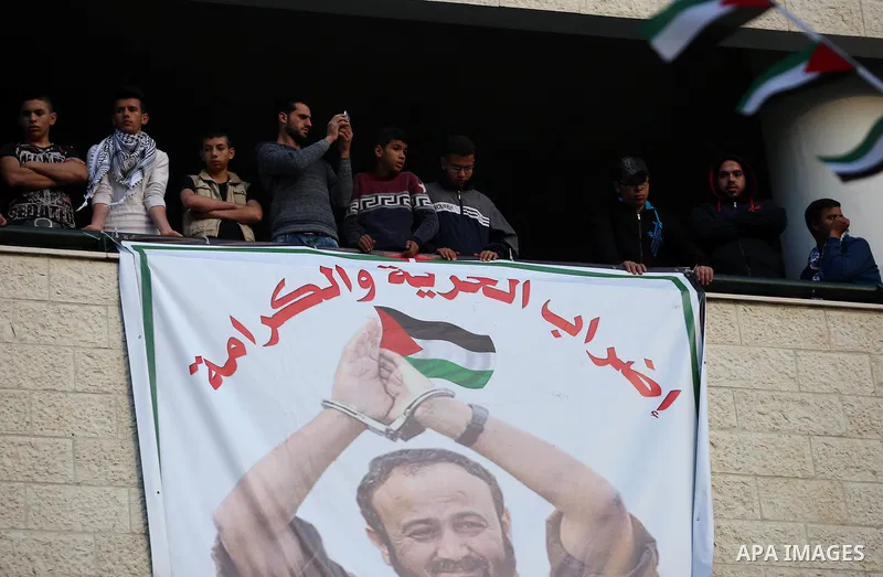 Palestinians hold pictures of relatives held in Israeli jails during a rally marking Palestinian Prisoner Day in the West Bank city of Nablus April 16, 2017. Photo by Stringer