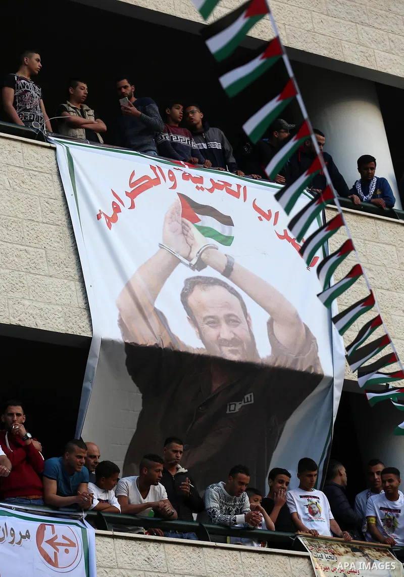 Palestinians hold pictures of relatives held in Israeli jails during a rally marking Palestinian Prisoner Day in the West Bank city of Nablus April 16, 2017. Photo by Stringer