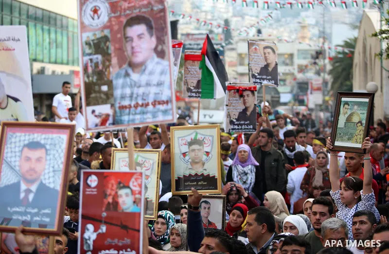Palestinians hold pictures of relatives held in Israeli jails during a rally marking Palestinian Prisoner Day in the West Bank city of Nablus April 16, 2017. Photo by Stringer