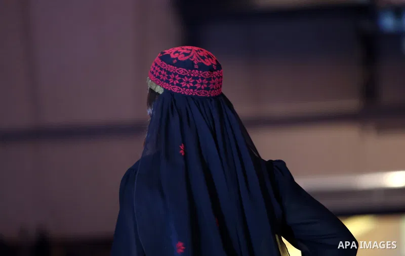 A picture taken on April 15, 2017 shows a Palestinian model displays a traditional Palestinian dress during a fashion show during the 2nd Nablus Festival for Culture and Arts, in the West Bank city of Nablus. The interna...