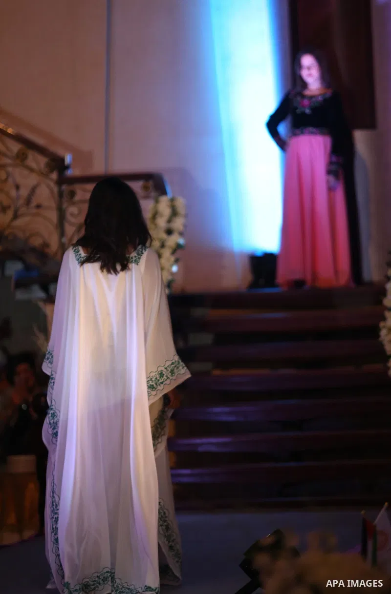 A picture taken on April 15, 2017 shows a Palestinian model displays a traditional Palestinian dress during a fashion show during the 2nd Nablus Festival for Culture and Arts, in the West Bank city of Nablus. The interna...