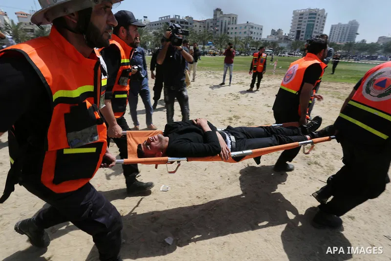 Palestinian Civil Defense members take part in a drill, in Gaza city, on April 18, 2017. Photo by Ashraf Amra
