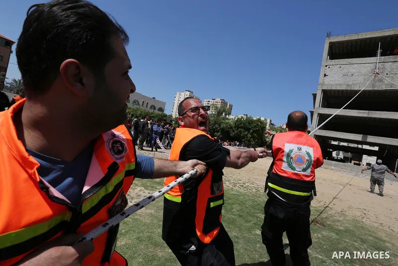 Palestinian Civil Defense members take part in a drill, in Gaza city, on April 18, 2017. Photo by Ashraf Amra