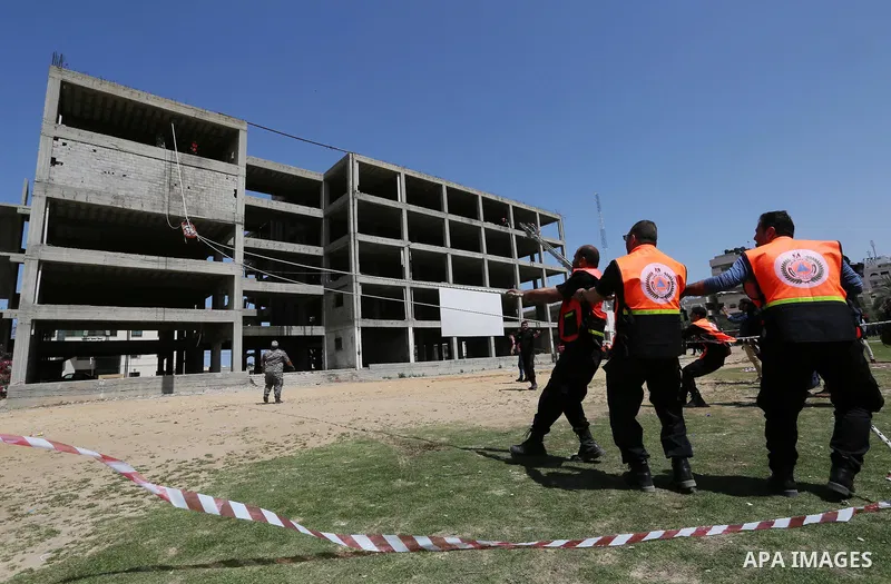 Palestinian Civil Defense members take part in a drill, in Gaza city, on April 18, 2017. Photo by Ashraf Amra