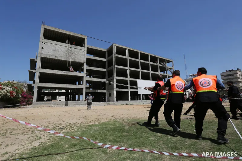 Palestinian Civil Defense members take part in a drill, in Gaza city, on April 18, 2017. Photo by Ashraf Amra