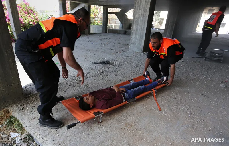 Palestinian Civil Defense members take part in a drill, in Gaza city, on April 18, 2017. Photo by Ashraf Amra