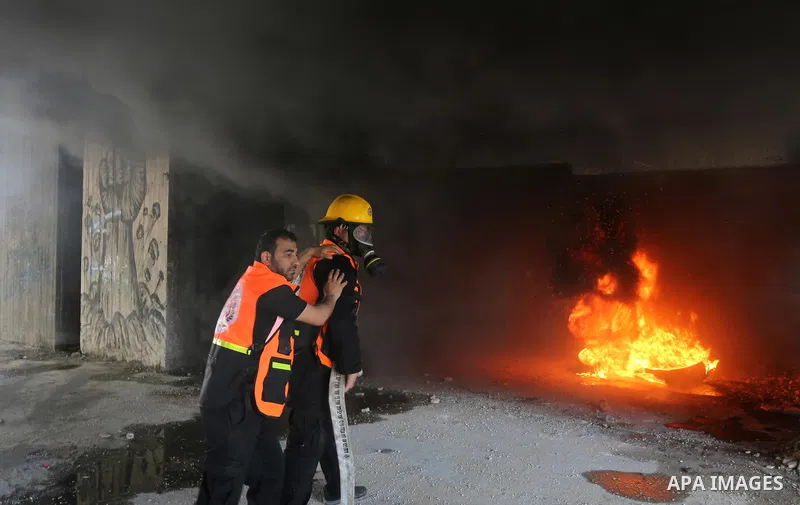 Palestinian Civil Defense members take part in a drill, in Gaza city, on April 18, 2017. Photo by Ashraf Amra