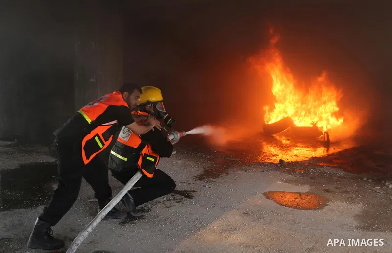 Palestinian Civil Defense members take part in a drill, in Gaza city, on April 18, 2017. Photo by Ashraf Amra