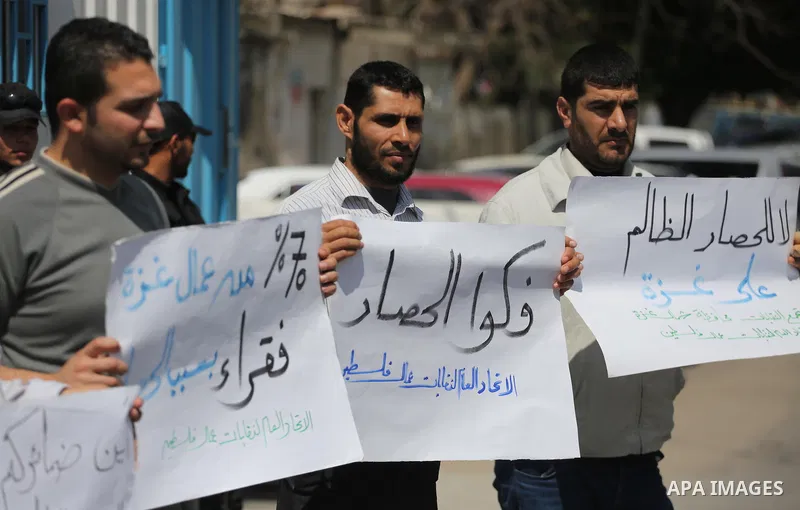 Union of the Palestinian syndicates members hold banners during a protest against Israeli blockade, in Gaza city, on April 19, 2017. Photo by Mohammed Asad