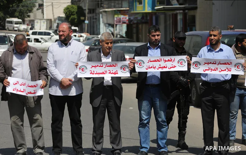 Union of the Palestinian syndicates members hold banners during a protest against Israeli blockade, in Gaza city, on April 19, 2017. Photo by Mohammed Asad