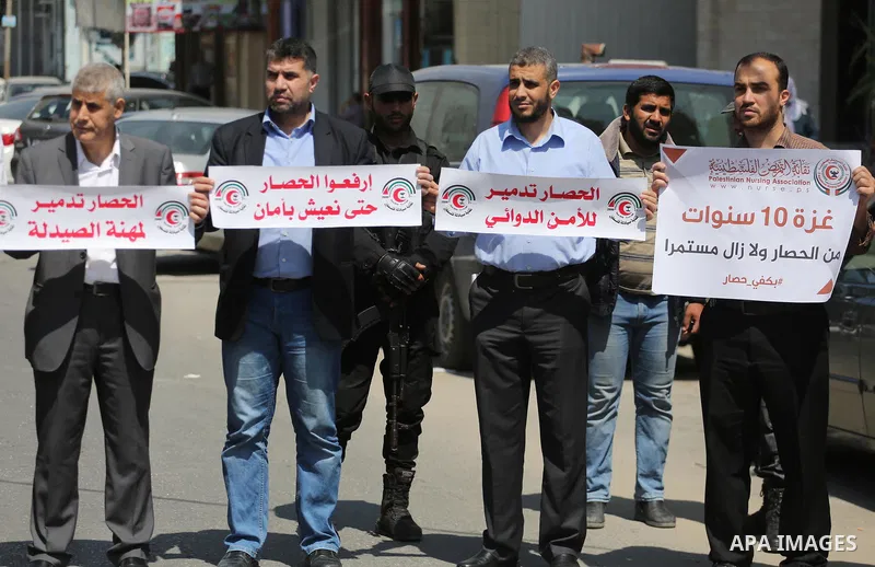 Union of the Palestinian syndicates members hold banners during a protest against Israeli blockade, in Gaza city, on April 19, 2017. Photo by Mohammed Asad
