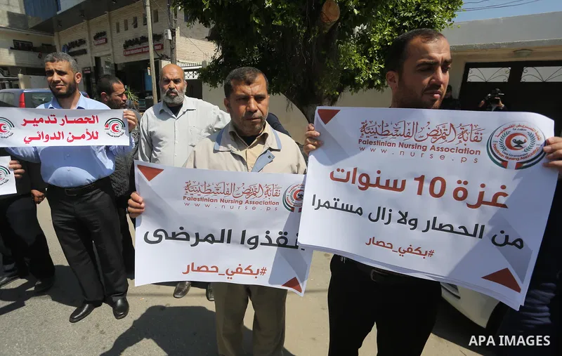 Union of the Palestinian syndicates members hold banners during a protest against Israeli blockade, in Gaza city, on April 19, 2017. Photo by Mohammed Asad