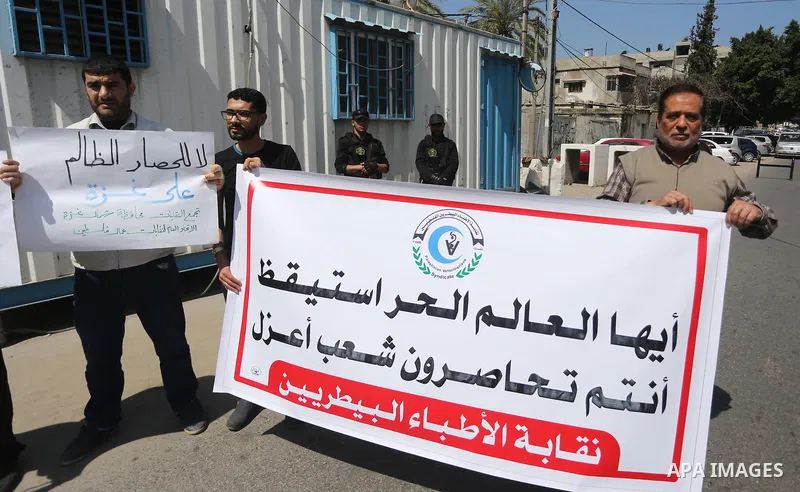 Union of the Palestinian syndicates members hold banners during a protest against Israeli blockade, in Gaza city, on April 19, 2017. Photo by Mohammed Asad