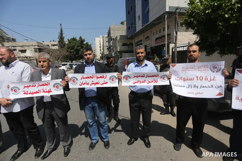 Union of the Palestinian syndicates members hold banners during a protest against Israeli blockade, in Gaza city, on April 19, 2017. Photo by Mohammed Asad