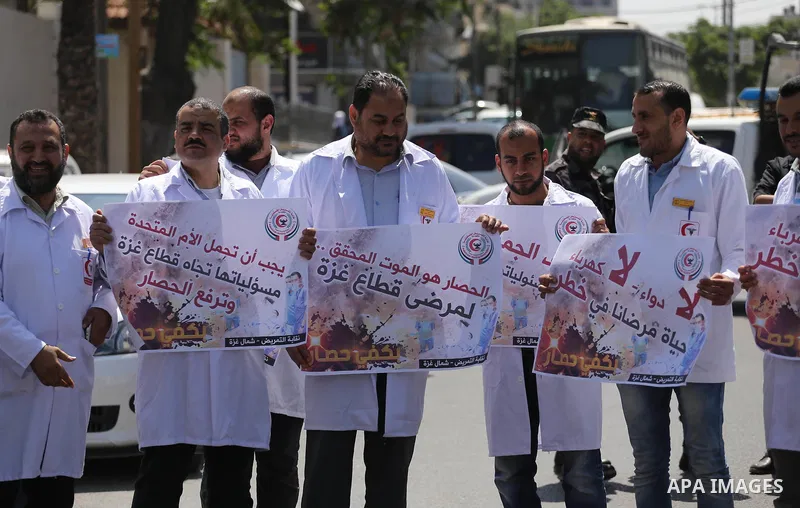 Union of the Palestinian syndicates members hold banners during a protest against Israeli blockade, in Gaza city, on April 19, 2017. Photo by Mohammed Asad