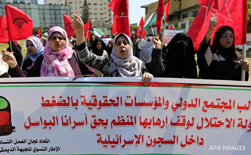 Palestinian supporters of the Democratic Front for the Liberation of Palestine (DFLP), hold banners during a protest to show solidarity with Palestinian prisoners on hunger strike in Israeli jails, in Gaza city on April...