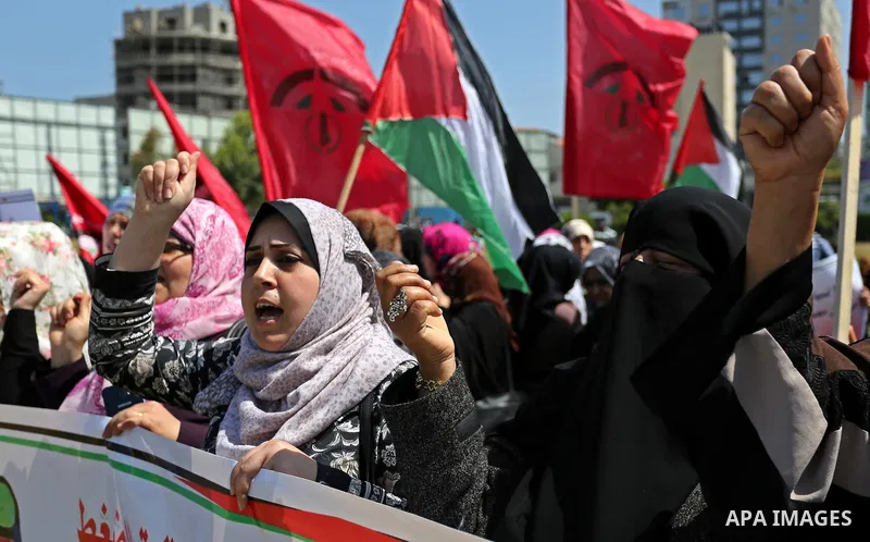 Palestinian supporters of the Democratic Front for the Liberation of Palestine (DFLP), hold banners during a protest to show solidarity with Palestinian prisoners on hunger strike in Israeli jails, in Gaza city on April...